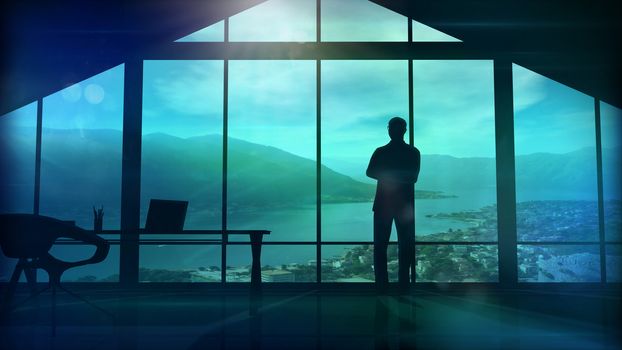 Silhouette of a man in a huge office in front of large windows.