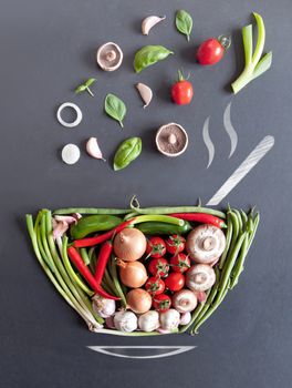 Vegetables falling into a bowl shape on a chalkboard with sketch of steam, spoon and saucer