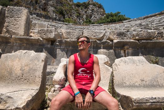 Young man at theatre in Myra ancient city of Antalya in Turkey.