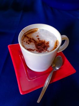 Coffe cup close-up of a delicious cup of coffee, Red plate, blue backgroud