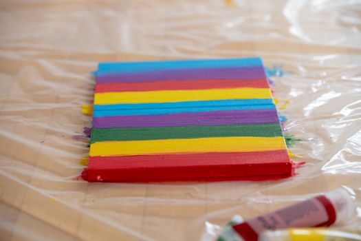 Painting rainbow on canvas with acrylic colors, close up, nobody