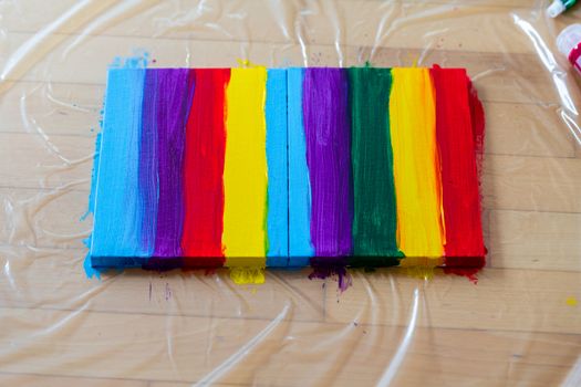 Painting rainbow on canvas, gay pride, transsexuality concept, sexual diversity