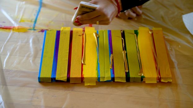 Female artist painting a rainbow with acrylic colors on canvas, hoe made art, DIY tutorial, colorful, mask taping painting for gold guilding