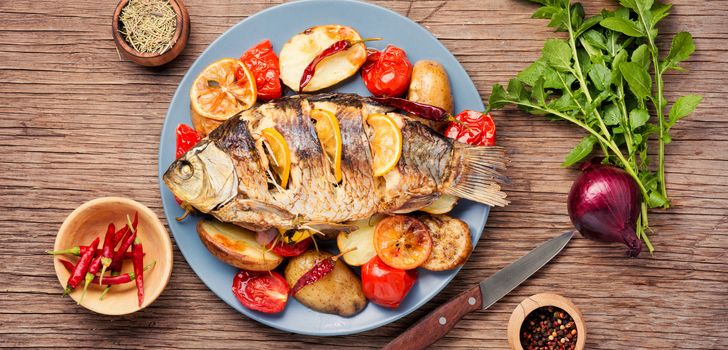 Delicious roasted fish with lemon and garnish.Diet and healthy food