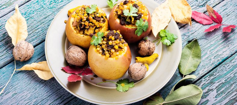 Apples baked with lentils, raisins and spices. Autumn meal.