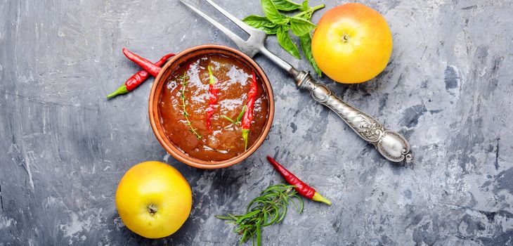 Apple sauce with chili and herbs. Sauce for meat or fish