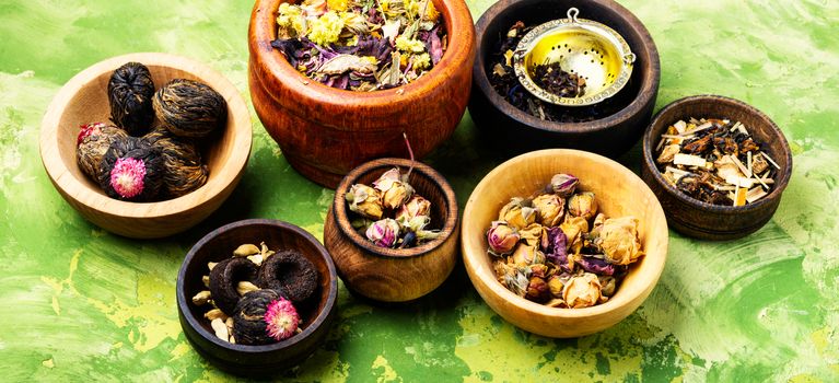 Assortment of dry tea in wooden bowls.Heap of dried tea