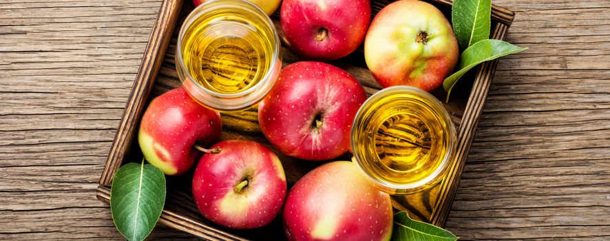 Apple cider with fresh apples on rustic background.Refreshing apple cider