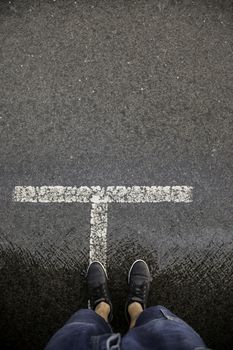 Feet on wet asphalt, rain detail