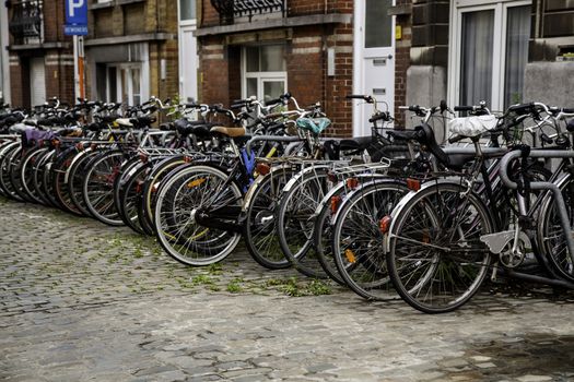 Typical bicycles parked in Holland, transport detail in the city, tourism in europe