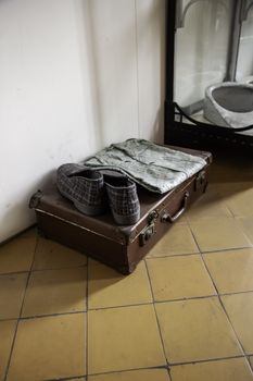 Old suitcases in a hospital, detail of clothes of sick patients