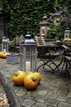 Garden table with pumpkins, decorated terrace detail of halloween