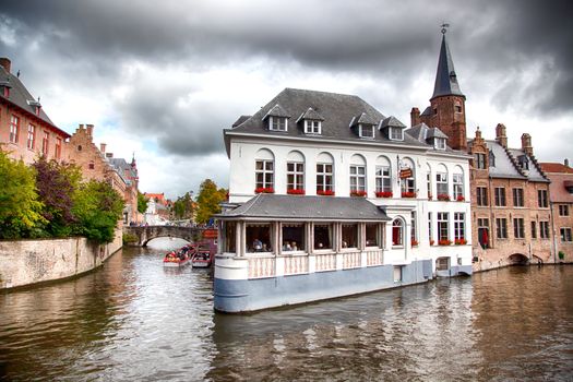 Medieval channels of Bruges, detail of tourism in a city of Belgium