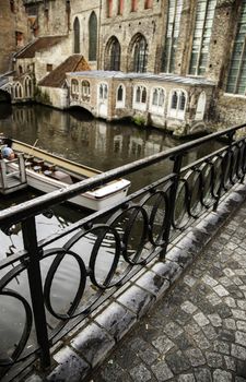 Medieval channels of Bruges, detail of tourism in a city of Belgium