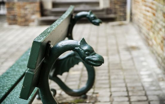 Old bench to sit, bench decorated with mythological animals