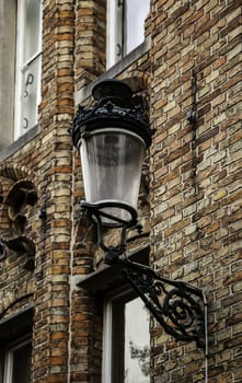 Old lamppost in bruges, lighting detail on a street in Belgium