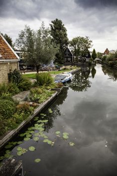 Medieval channels of Bruges, detail of tourism in a city of Belgium