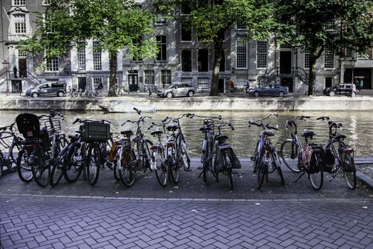 Bicycles parked in Amsterdam, transportation detail for people, tourism in Europe