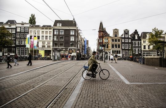 Bicycles in Amsterdam, people cycling, tourism in Europe