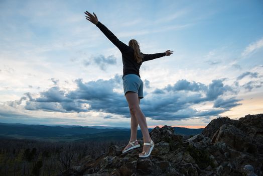 Travel, lesure and freedom concept - woman on the top of Altai mountain, beauty summer evening landcape