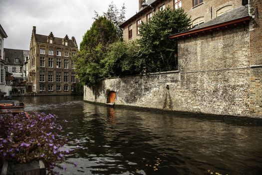 Medieval channels of Bruges, detail of tourism in a city of Belgium