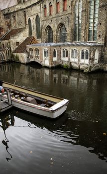 Medieval channels of Bruges, detail of tourism in a city of Belgium