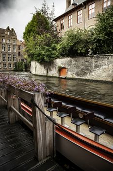 Medieval channels of Bruges, detail of tourism in a city of Belgium