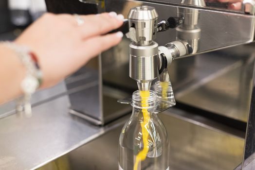 Filling a bottle from orange juice maker