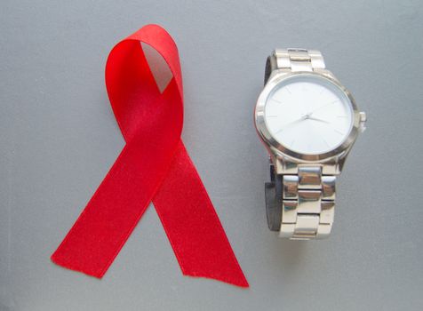 World AIDS day, the symbol of the red ribbon and the clock - do not waste time to start treatment.