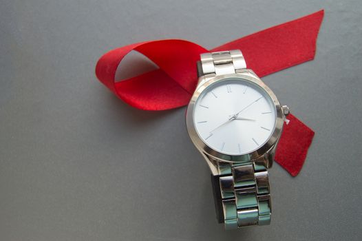 World AIDS day, the symbol of the red ribbon and the clock - do not waste time to start treatment.