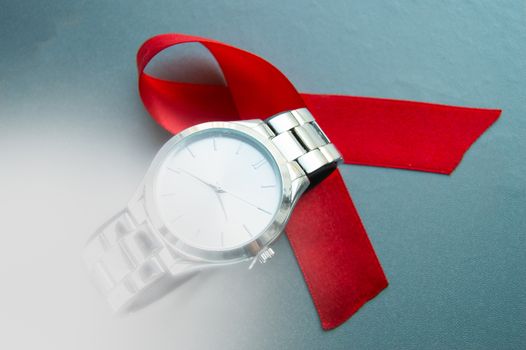 World AIDS day, the symbol of the red ribbon and the clock - do not waste time to start treatment.