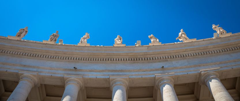 Rome, Vatican State. Details of columns of Saint Peter Square with copyspace on blue