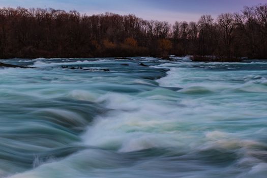 American side of the Niagara River at sunset, New York, USA.