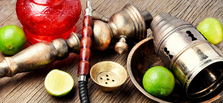 Traditional oriental smoking hookah with citrus lime flavor.Stylish lime shisha