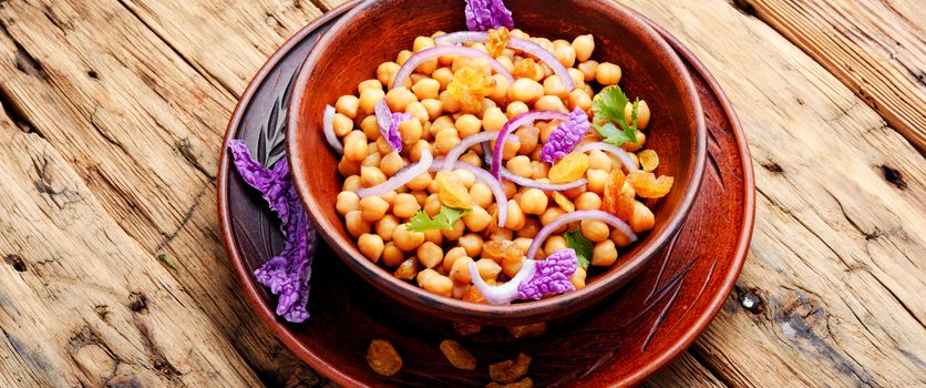 Vegan healthy salad with chickpeas and raisins