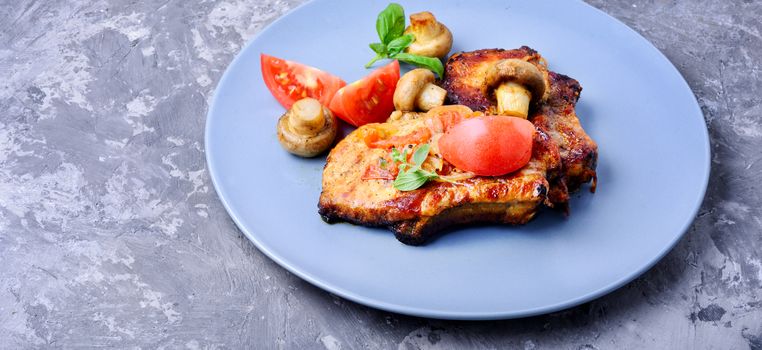 Grilled meat steak,tomato, herbs and spices on the plate.Bbq meat