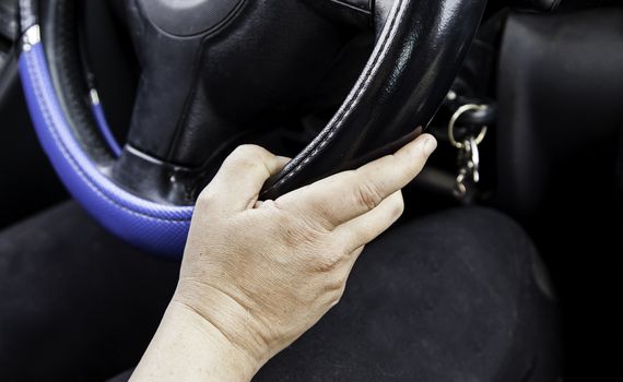 Hands woman driving, detail of young girl in a modern car, transport