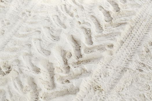 Footprint in the sand, detail of a wheel tracks