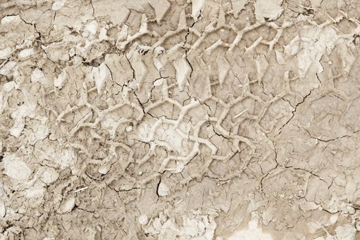 Footprint in the sand, detail of a wheel tracks