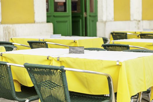 Terrace of a bar on the street, detail of a few tables and chairs