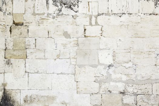 Old stone wall, detail of a damaged wall and eroded by time