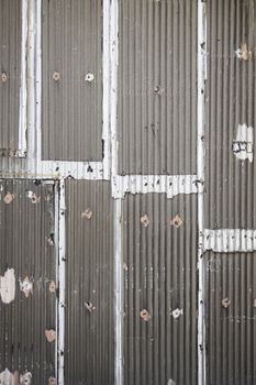 Old metal fence detail of a textured, rusty