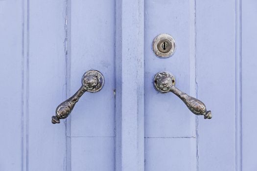 Old decorated door in blue, detail of urban decoration, protection