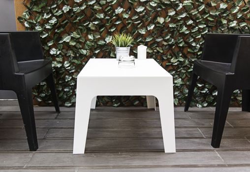 Tables and chairs for breakfast, detail of a sunroom