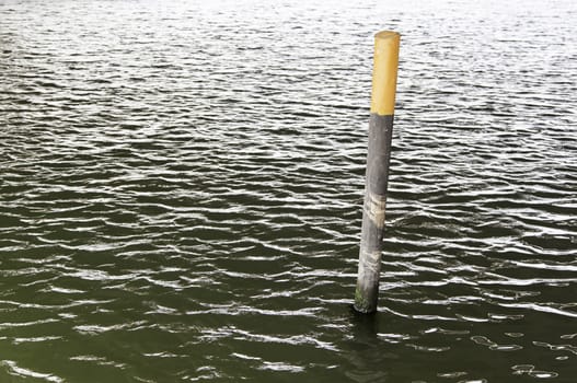 Mooring pole in the water, detail object to tie boats