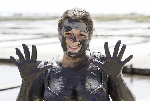 Woman giving himself a mud bath, detail of a classical health therapy