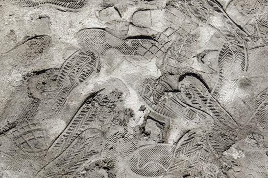 Footprints in the mud, detail of a shoe brands