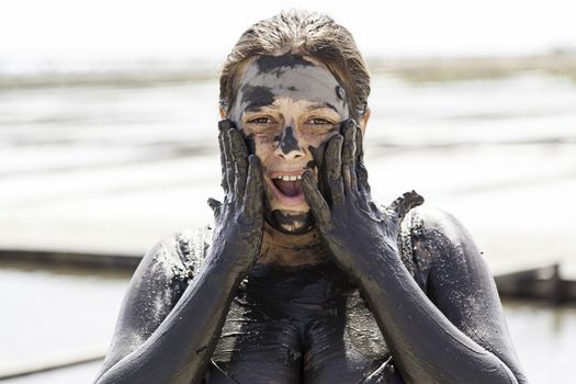 Woman giving himself a mud bath, detail of a classical health therapy