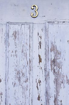 Old decorated door in blue, detail of urban decoration, protection