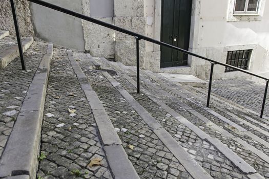 Black stone staircase, detail of a staircase, pedestrians